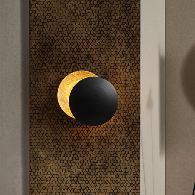 Applique murale LED design eclipse solaire, décoration intérieure contemporaine, finition or brillant.
