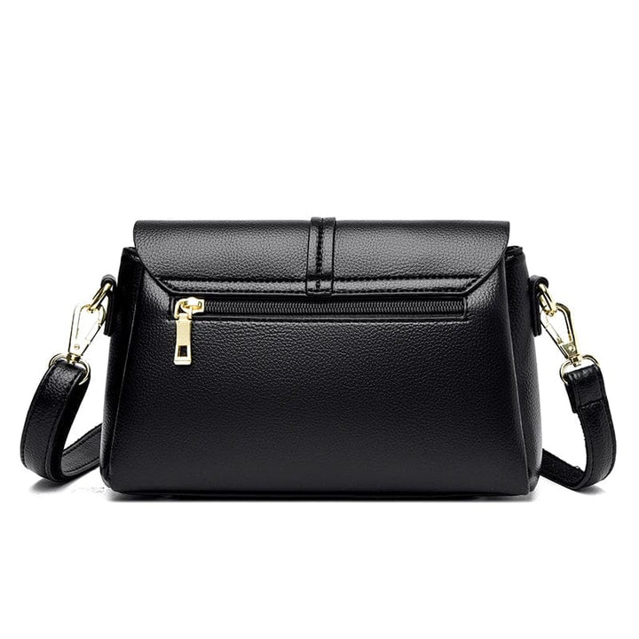 Fermoir doré élégant du sac besace femme noir en cuir PU. Détail chic pour un sac à main mode.