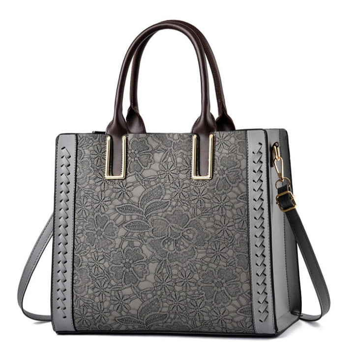 Sac à main de luxe pour femme en cuir gris, accessoire de mode chic et pratique au quotidien.
