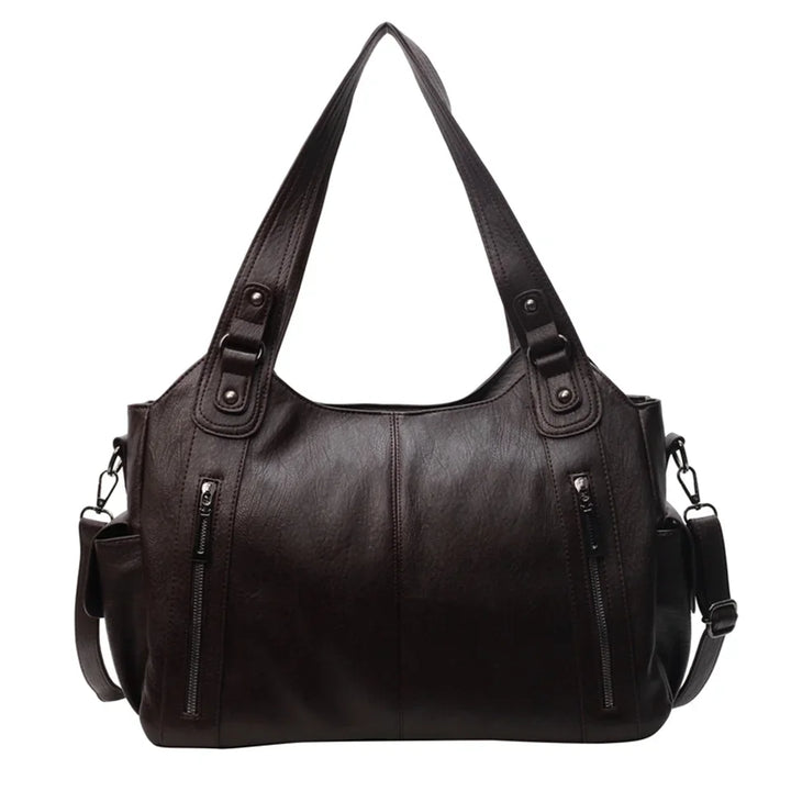 Fermeture éclair, détails dorés et finitions du sac cabas femme Magda, pour un style raffiné.