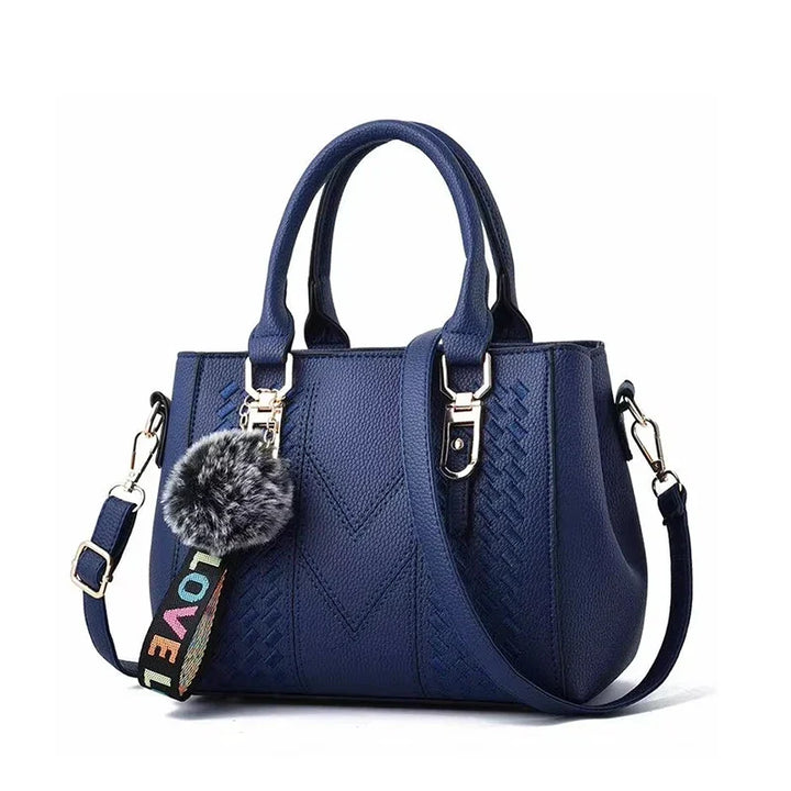 Sac à épaule femme élégant en cuir brodé avec pompon. Accessoire mode chic, parfait pour le quotidien.