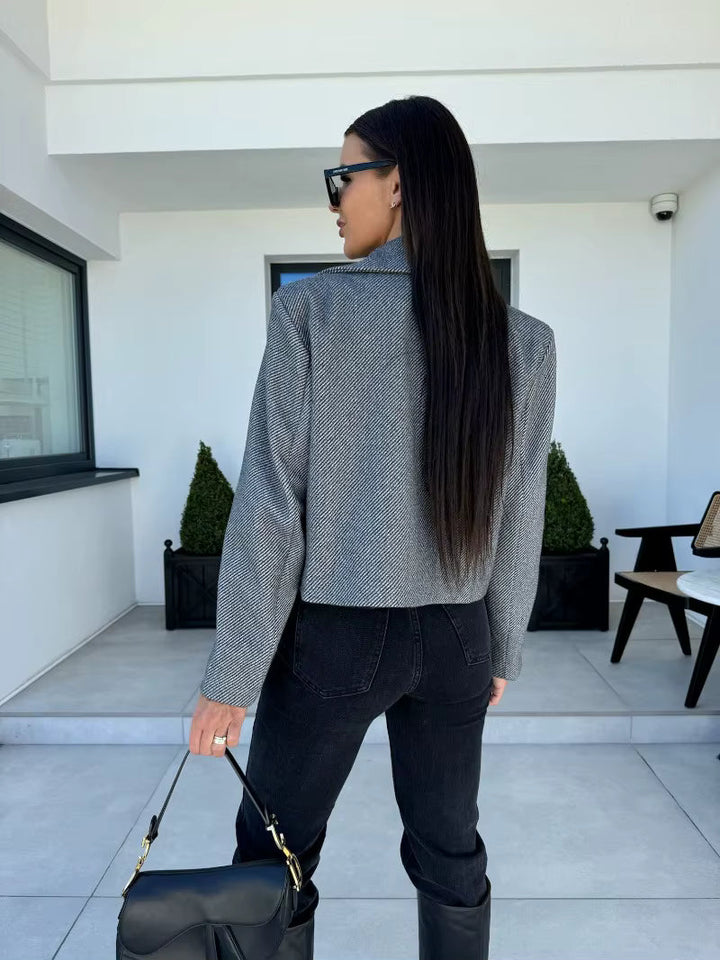 Blazer femme chic noir, coupe courte moderne, parfait pour une tenue décontractée élégante.
