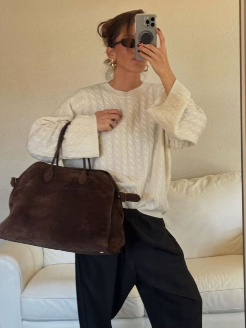 Sac bandoulière en cuir posé sur une table, prêt pour une journée de travail ou une escapade de voyage.