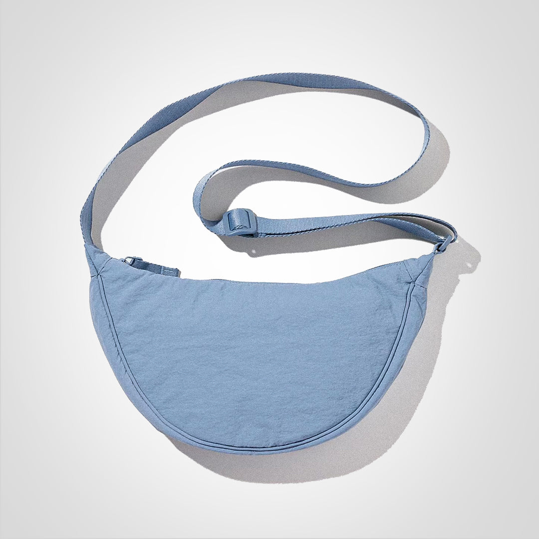 Sac décontracté à bandoulière pour voyage, avec multiples compartiments pour une organisation facile.