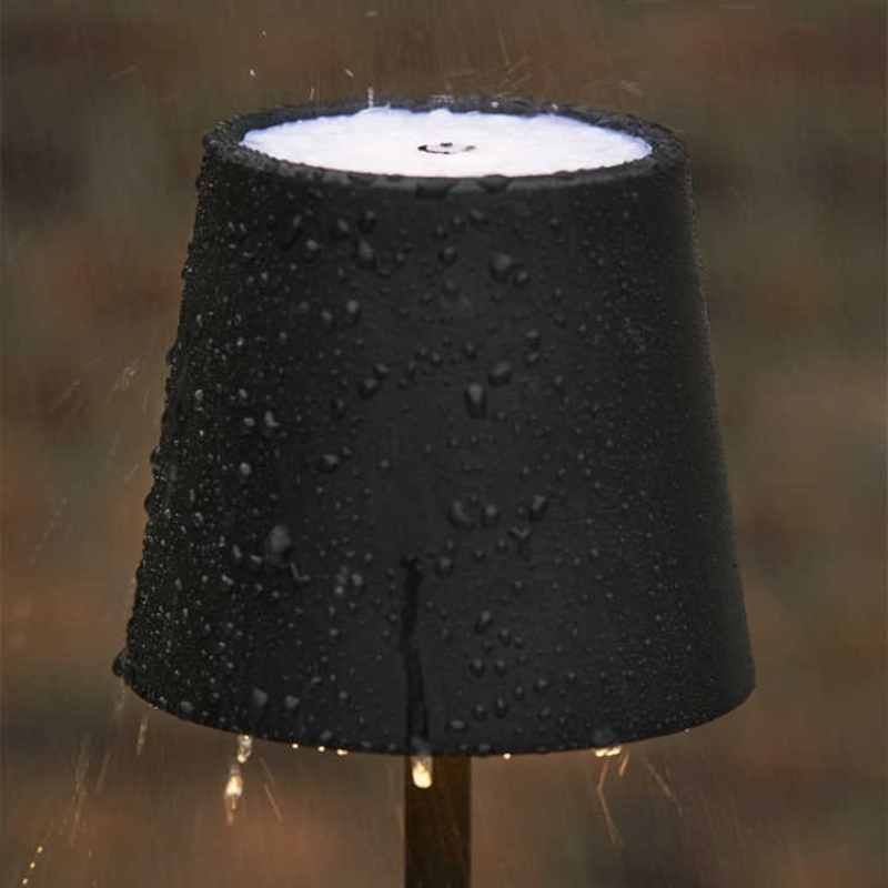 Lampe de table LED noire, sans fil, rechargeable, lumière ajustable pour travail ou détente.