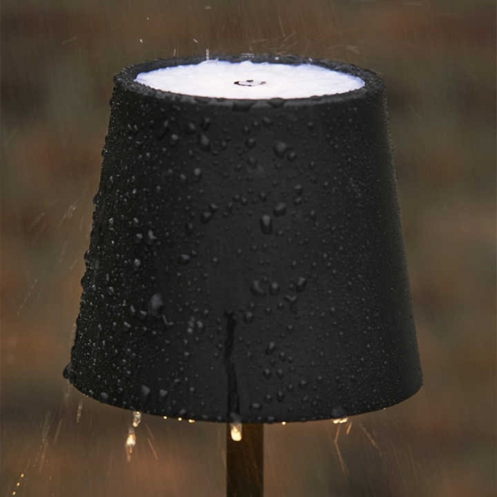 Lampe de table LED noire, sans fil, rechargeable, lumière ajustable pour travail ou détente.