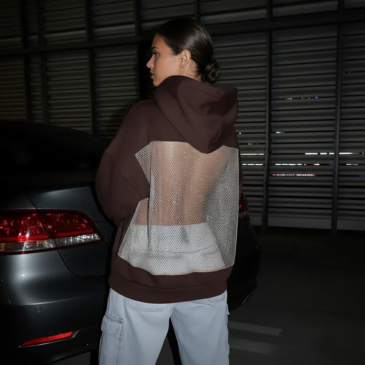 Hoodie scintillant polyvalent pour femme, coupe moderne, idéal pour un look de soirée ou un style quotidien branché.