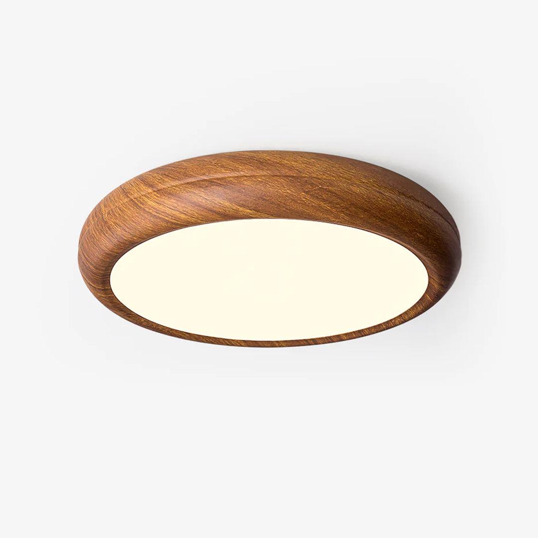 Plafonnier LED rond, bordure en bois, diffuse une lumière uniforme.