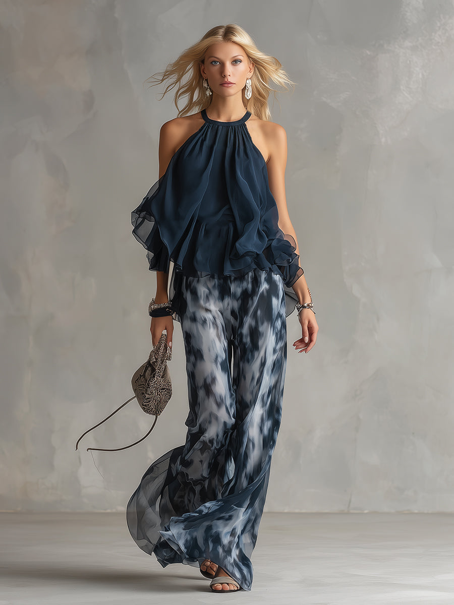 Tenue de soirée fluide femme, ensemble deux pièces imprimé marbré: top halter et pantalon large. Chic.