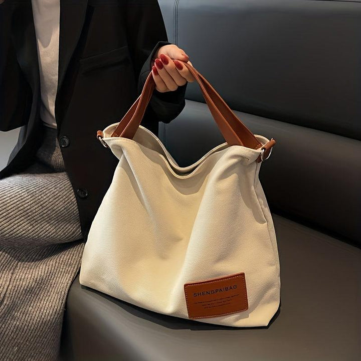 Sac bandoulière unisexe pratique pour le travail ou les loisirs. Toile durable, style élégant.