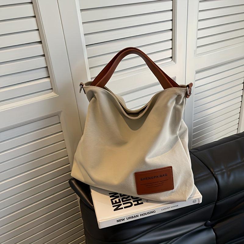 Sac toile polyvalent, bandoulière confortable. Design élégant et minimaliste, parfait pour toute occasion.
