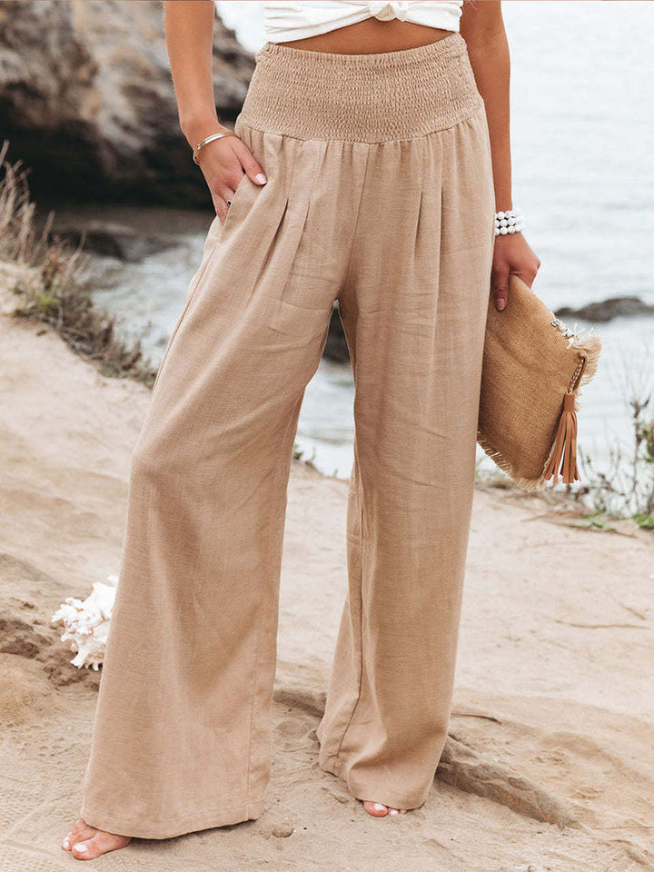 Pantalon palazzo blanc fluide femme, jambes larges, taille élastique, idéal pour l'été.