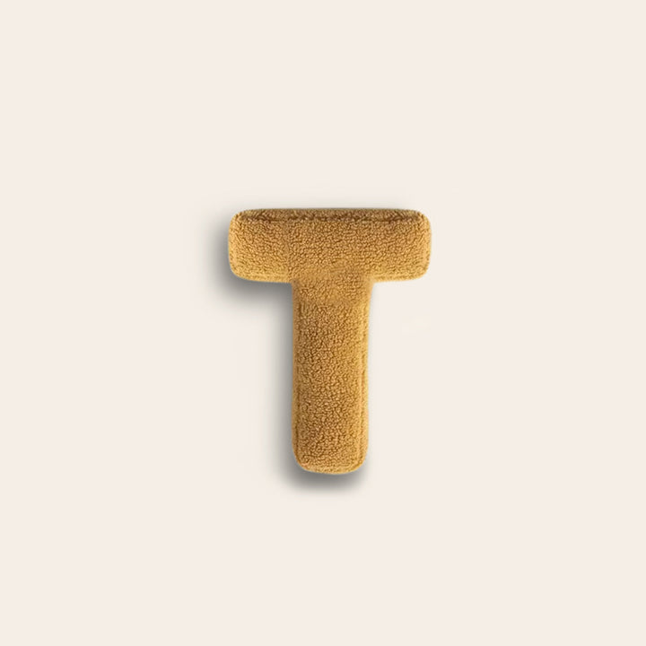 Coussin décoratif lettre T, en coton pour un salon moderne et chic.