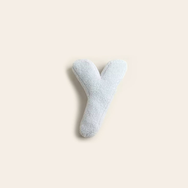 Coussin moderne lettre X, décoratif et confortable pour chambre.