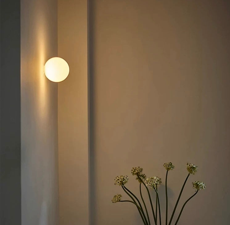 Détail de l'applique murale boule en verre soufflé, avec son support discret. Design épuré, éclairage LED intégré.
