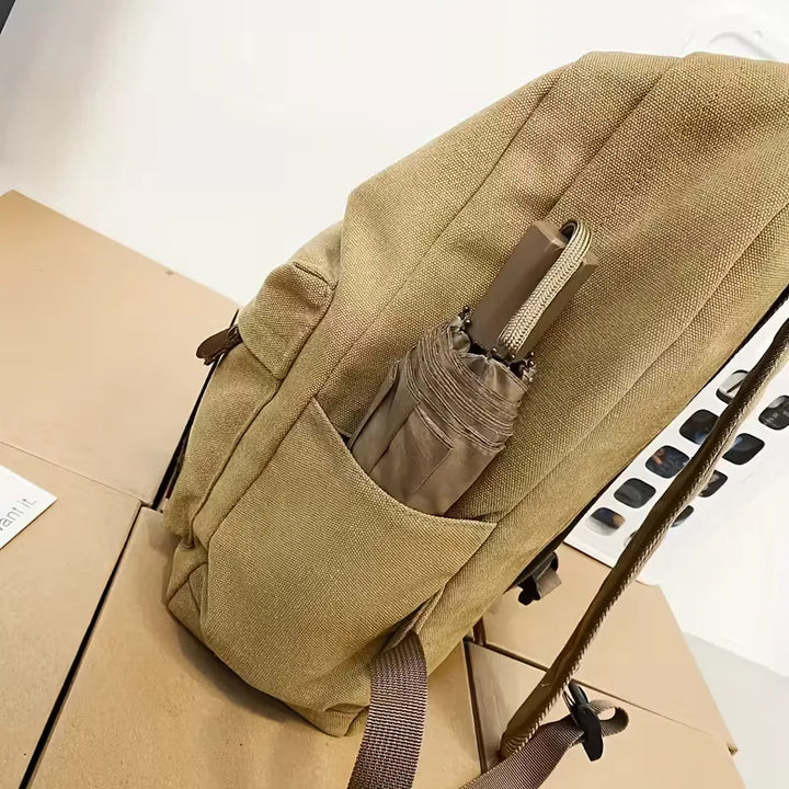 Sac à dos noir en canvas résistant, idéal pour l'organisation quotidienne et urbaine.