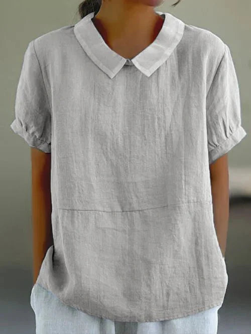 Blouse femme à col raffiné et manches courtes. Tissu fluide, style élégant décontracté, chic pour le quotidien.