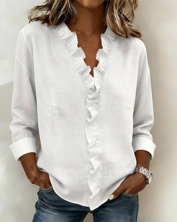 Blouse rose à volants pour femme, avec col V et manches longues. Idéale pour un look féminin et tendance.