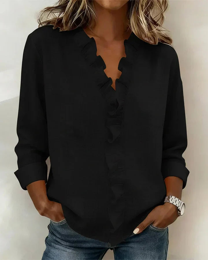 Chemisier femme noir à volants, col V et manches longues. Style chic et élégant pour la mode féminine.