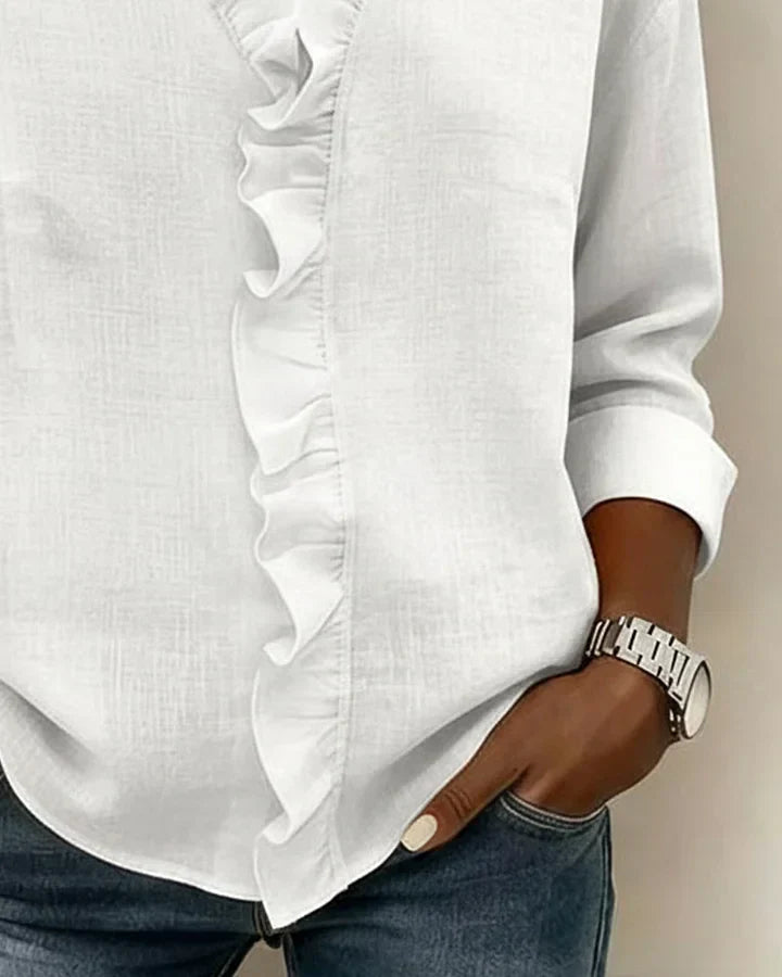 Blouse femme à manches longues et col V, ornée de volants. Disponible en rose, blanc ou noir. Mode féminine.