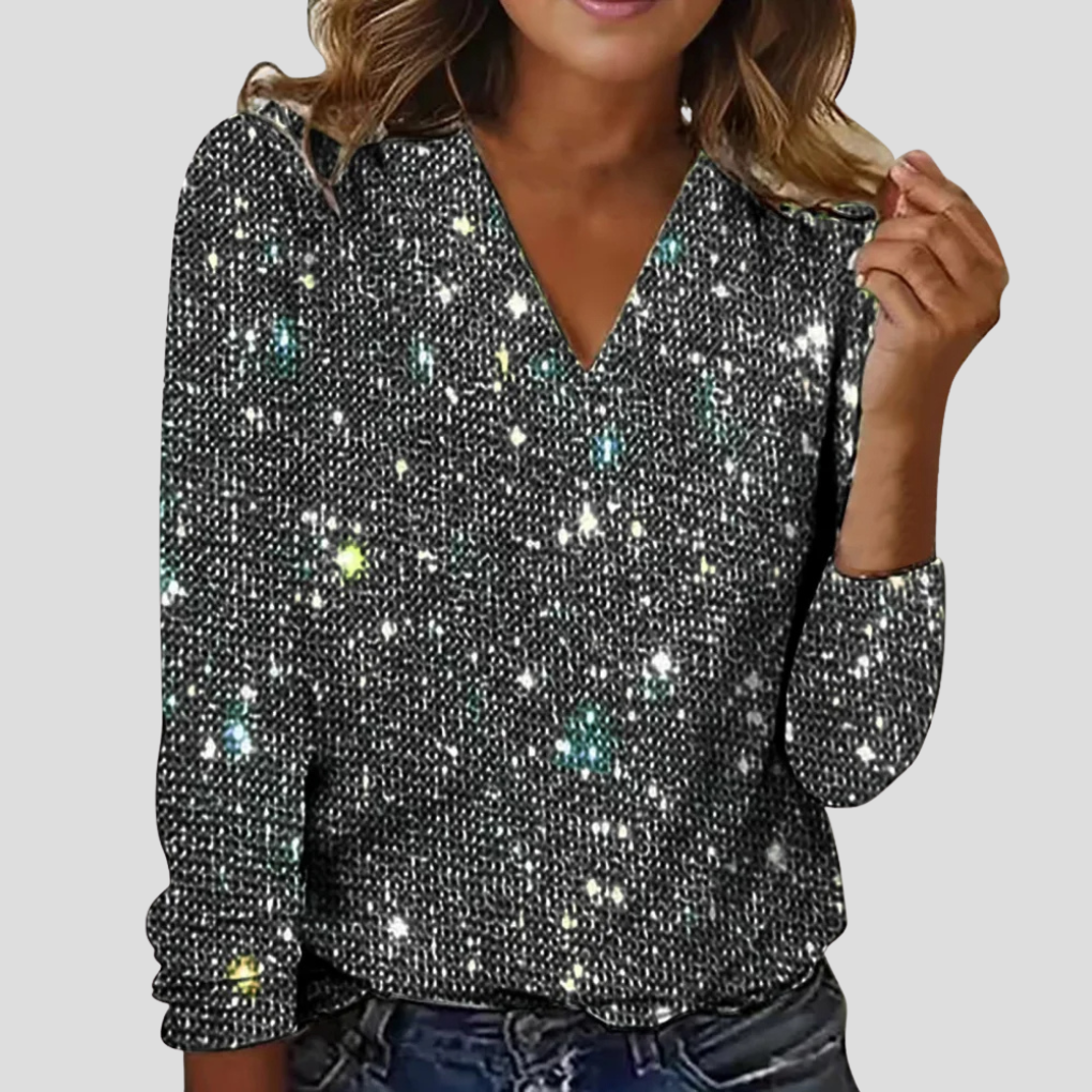 Blouse festive femme avec col V et paillettes brillantes. Manches longues. Look mode chic pour soirée spéciale.