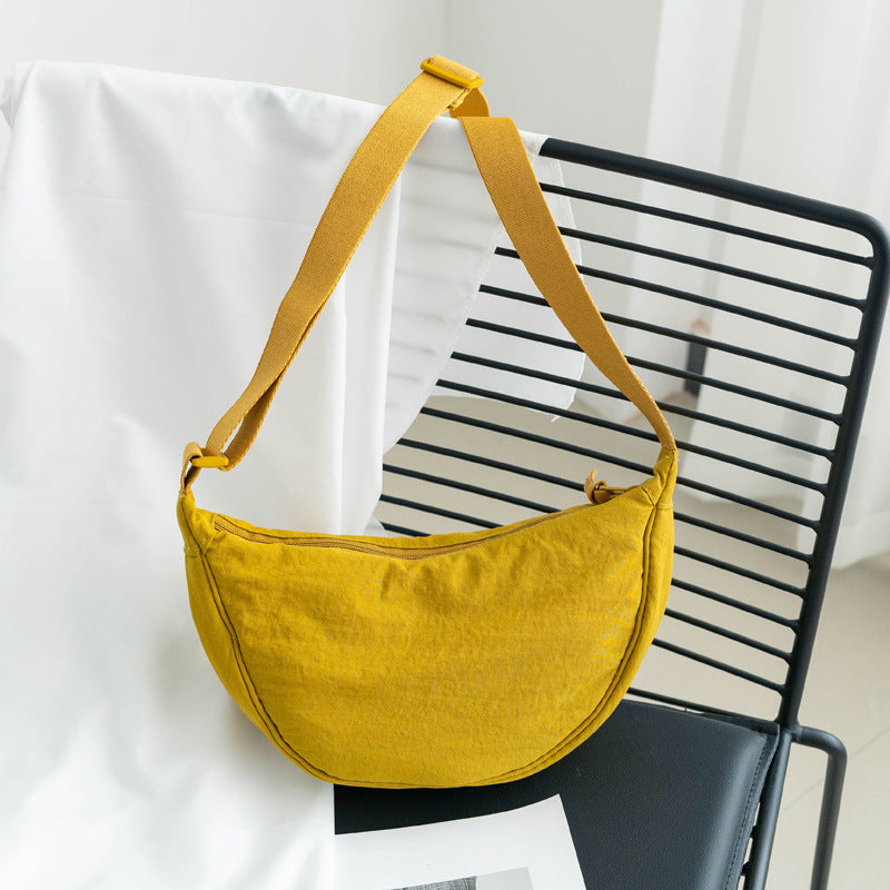 Sac à bandoulière en nylon demi-lune pour femme. Ce sac ajustable est un accessoire mode essentiel.