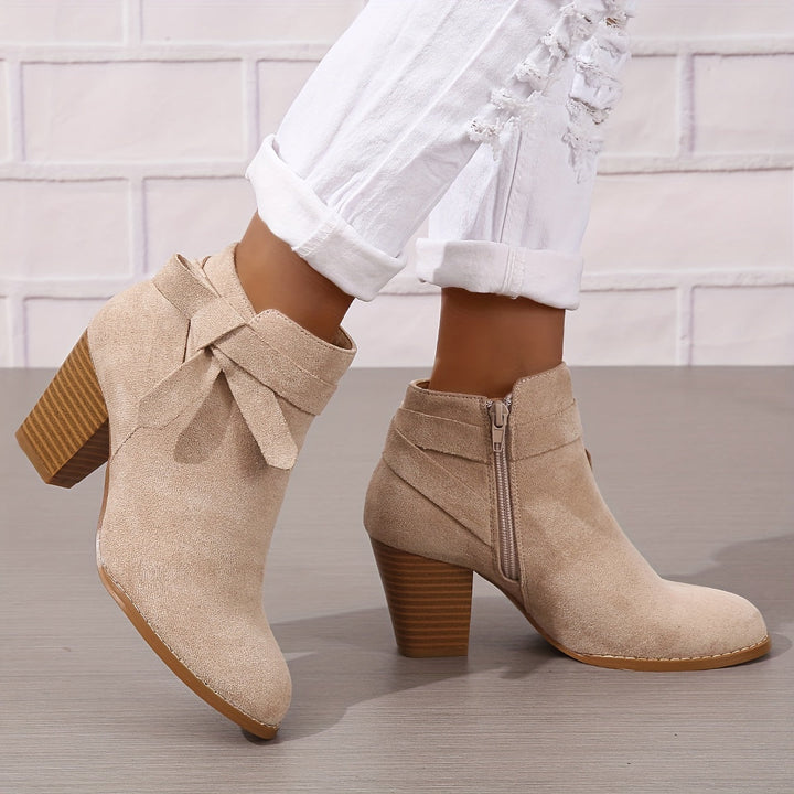 Élégantes bottines noires pour femme, caractérisées par leur talon large et leur nœud chic, très tendance.