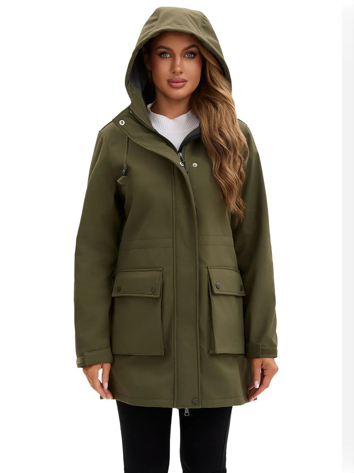 Veste femme avec capuche ajustable, fermetures étanches, idéale pour la randonnée et le sport.