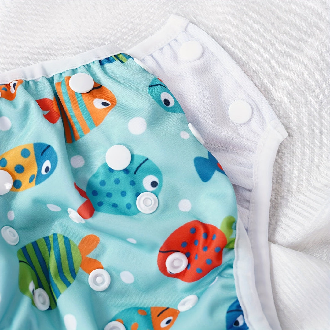 Maillot de bain bébé lavable, ajustable avec des motifs de poissons, tortues et crabes.