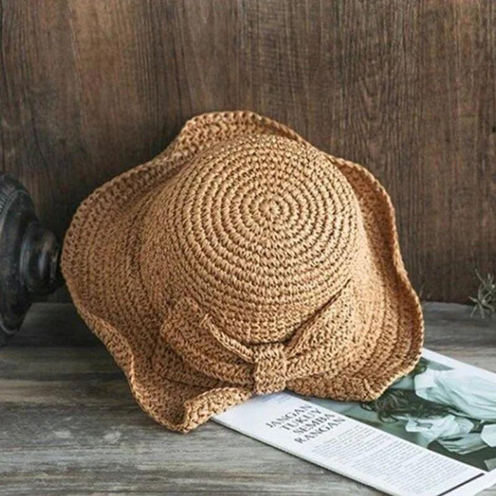 Chapeau estival femme, grand bord et nœud. Accessoire mode indispensable pour la plage, protection solaire élégante.