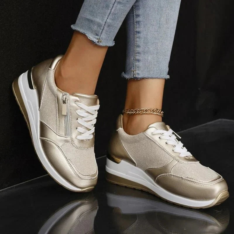 Vue latérale de chaussures de sport roses pour femmes, avec fermeture éclair or, confortables et élégantes pour la marche.