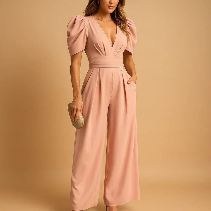 Combinaison longue femme ajustée noire, manches bouffantes, parfaite pour une tenue de soirée élégante et formelle.
