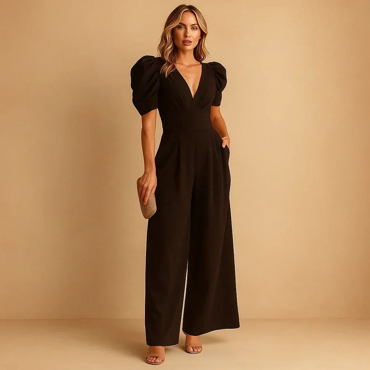 Jumpsuit élégante pour femme avec manches bouffantes volumineuses et coupe ajustée, idéale pour événements habillés.