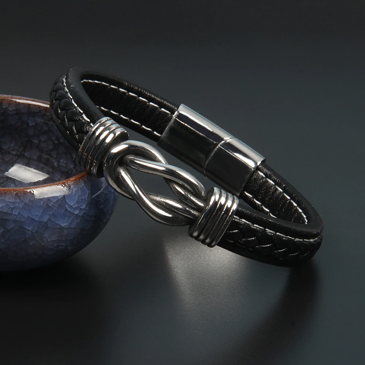 Bracelet unisexe nœud infini noir, élégant accessoire de mode intemporel pour poignet.