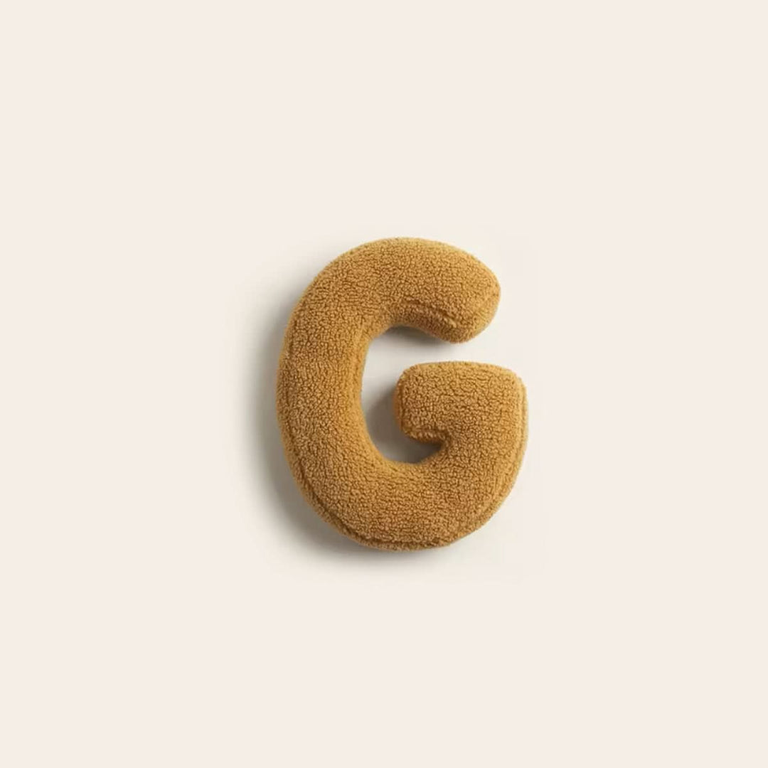 Coussin décoratif G, personnalisable, ajoute une touche unique à votre maison.