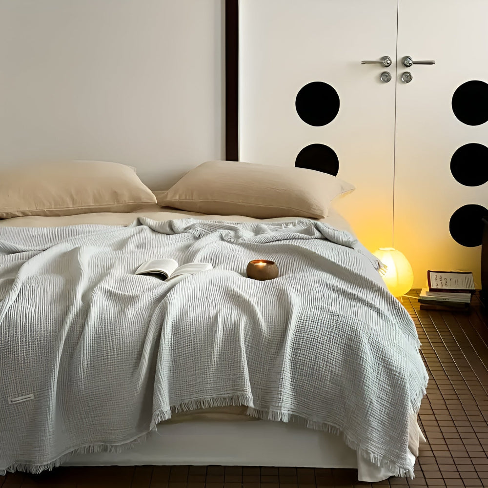 Jeté de canapé en coton gaufré. Ce plaid doux avec franges apporte chaleur et style à votre intérieur.