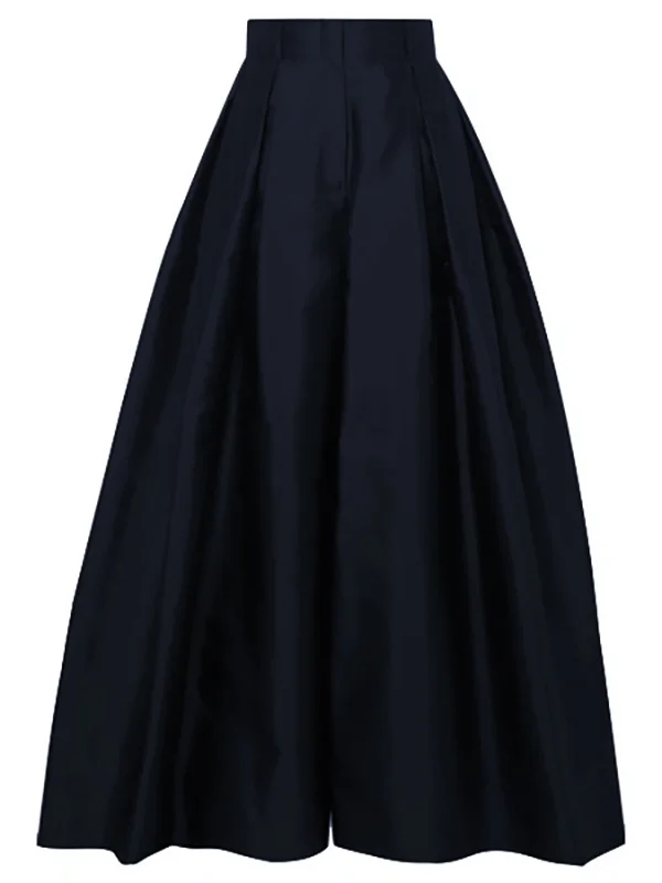 Silhouette d'une femme portant un pantalon plissé taille haute, jambe large. Mode femme automne, élégance fluide.