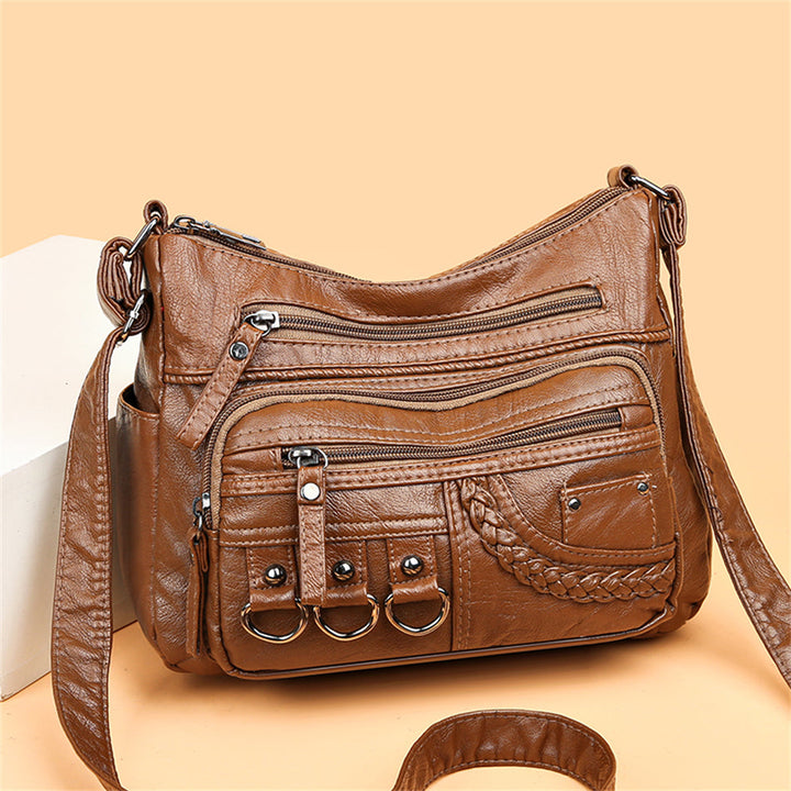 Sac à main noir vintage chic pour femme, avec bandoulière ajustable, parfait pour le quotidien.