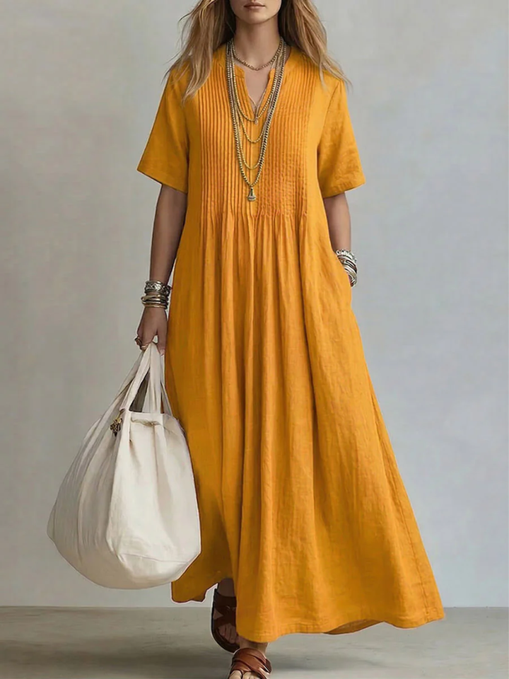Robe maxi fluide d'été pour femme, col V et manches courtes. Parfaite pour les vacances, chic et confortable.
