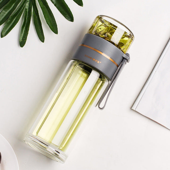 Bouteille PureBrew en verre réutilisable, verte, isotherme avec infuseur pour vos boissons préférées en déplacement.