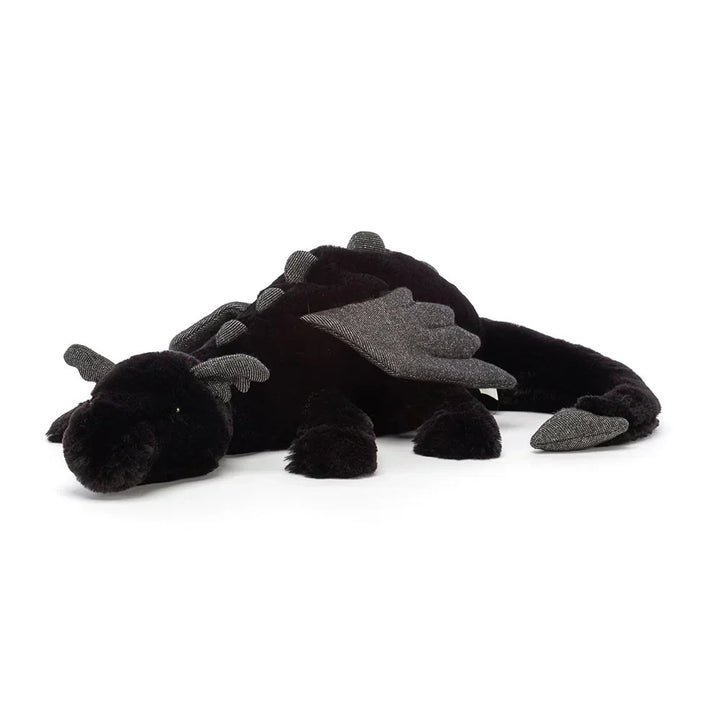 Peluche dragon polyvalente, jouet câlin ou décoration de chambre. Apporte fantaisie et douceur à l'espace.