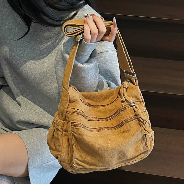 Sac pour femmes en toile avec bandoulière réglable. Compact, élégant et multi-poches pour vos essentiels.