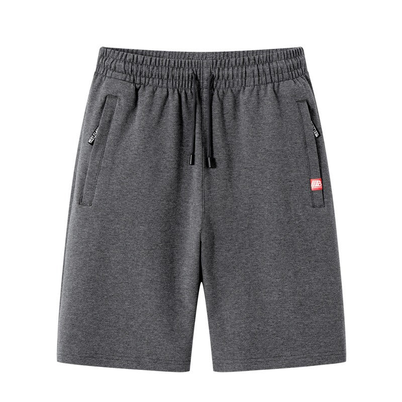 Short de gym homme performant, gris anthracite, doté de poches zippées pratiques. Idéal pour l'entraînement intensif.