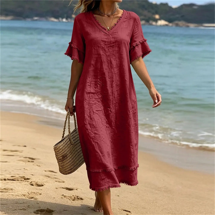 Robe femme bohème fluide en polyester léger, col V, détails frangés. Parfaite pour un confort maximal en été/printemps.