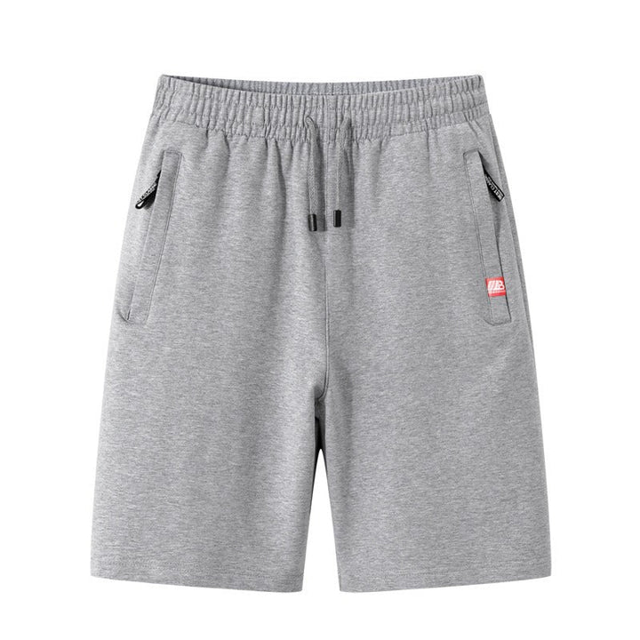 Short homme confortable kaki pour l'été. Design polyvalent avec poches zippées, parfait pour activités sportives ou loisirs.