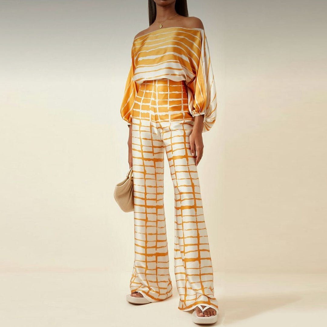Ensemble femme décontracté-chic: haut asymétrique moderne et pantalon large confortable, parfait pour une sortie estivale.