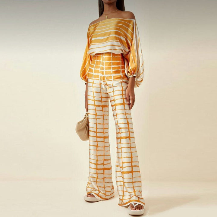 Ensemble femme décontracté-chic: haut asymétrique moderne et pantalon large confortable, parfait pour une sortie estivale.