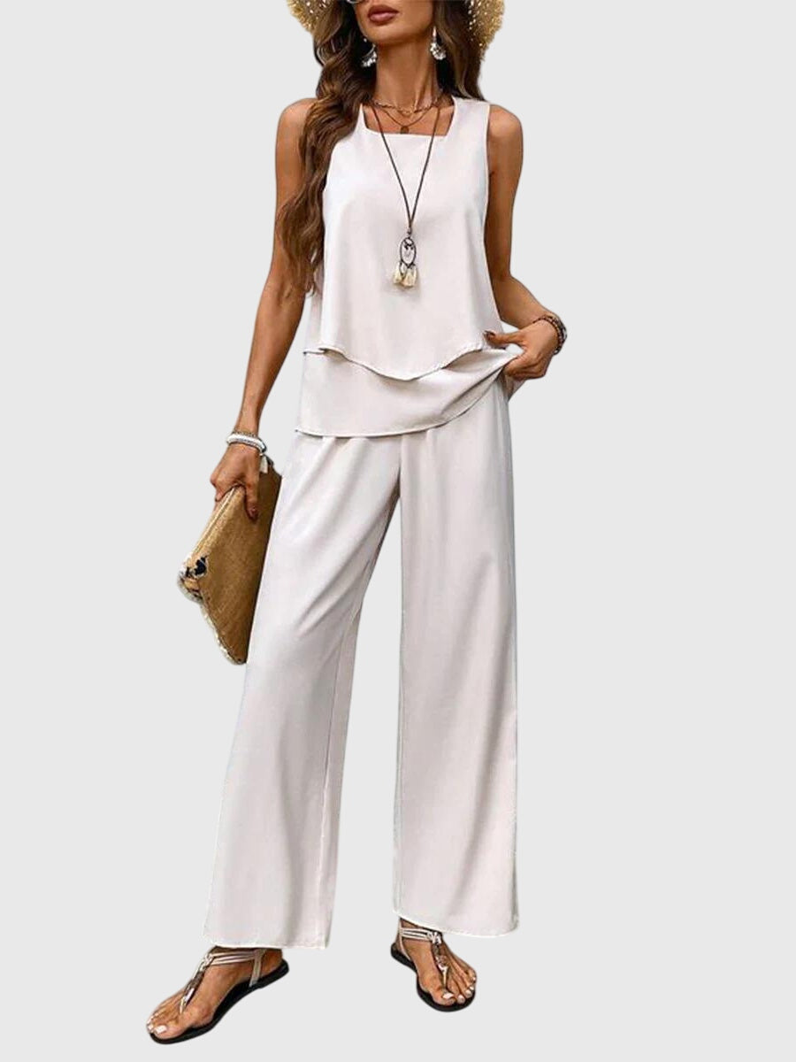 Pantalon large fluide femme à imprimé floral vibrant et top sans manches assorti pour un look estival mode.