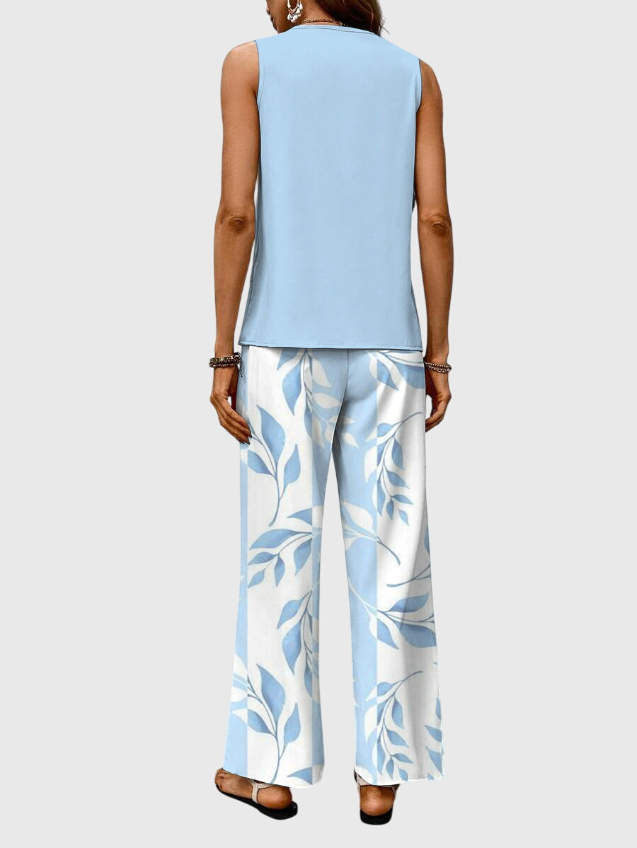 Ensemble femme printanier, pantalon fluide large imprimé floral et top élégant, parfait du jour à la soirée.
