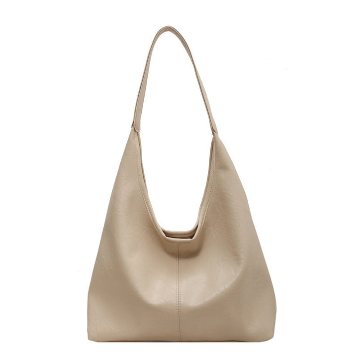 Grand sac bandoulière femme en cuir vegan, spacieux et chic, avec pochette assortie.